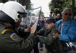 Greece protests: Pensioner push anti-riot policeman during protest, Athens, Greece