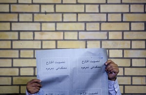 24 hours in pictures: An Iraqi living in Tehran looks at a ballot paper 