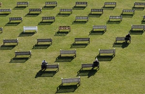 24 Hours in Pics: Spectators relax on benches in front of the granstand at Newbury Racecourse