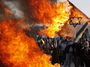 24 Hours in Pics: Jordanian Muslims burn an Israeli flag during a rally in Amman