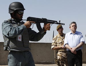 24 Hours in Pics: Gordon Brown watches a display at the Helmand police training centre 