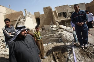 Elections in Iraq: People gather at the scene of an explosion at Kre'at