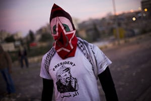 24 hours in pictures: Jerusalem: A masked Palestinian during clashes