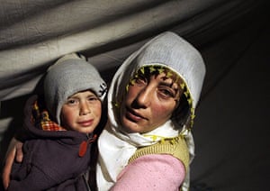 24 hours in pictures: Okcular, Turkey: Survivors inside a tent near their destroyed house