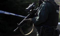 A Northern Ireland police officer on guard at Newtownhamilton station during a bomb scare this week