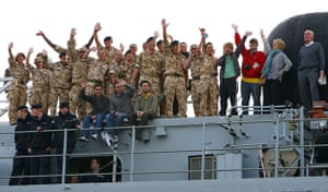 Return of the Albion: Troops and civilians wave as they arrive aboard HMS Albion at Portsmouth