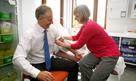 Tony Blair has his blood pressure taken during a visit to Alexandra Avenue polyclinic in Harrow