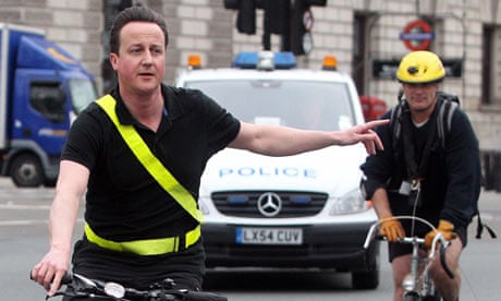 Conservative party leader David Cameron arrives by bicycle at the House of Commons in central London