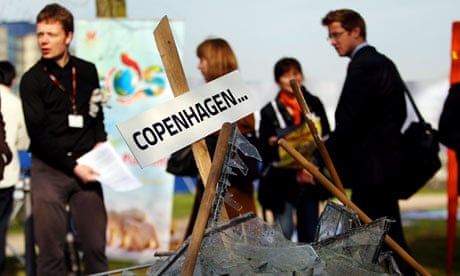 Delegates of the UN climate change talks pass a symbolic pile of broken glass in Bonn, Germany