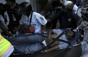 Thailand protests: Medics carry an injured person
