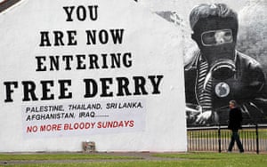 Bloody Sunday Inquiry: A man walks past a Bloody Sunday mural in the Bogside area of Londonderry