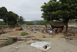 Brazil floods: A man sleeps next to a camp in Rio Largo city