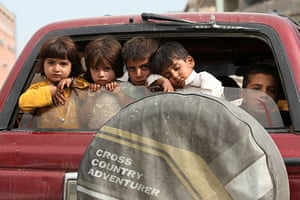24 hours : Kabul, Afghanistan: Children sit in the back of a truck