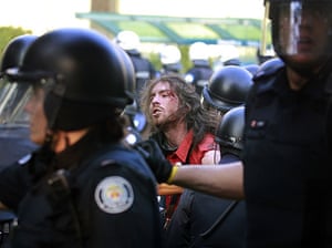G20 protests: A protester is detained by riot police