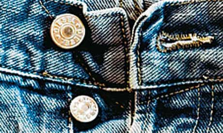 Button fly of an old faded pair of denim jeans