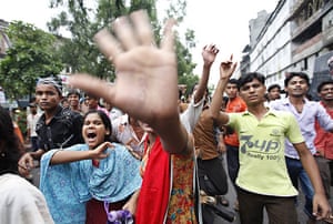 Dhaka protests: Garment workers shout slogans as they block a street in Dhaka