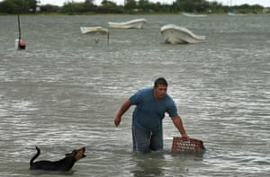 Hurricane Alex: A man hauls a box to shore in preparation for the arrival of Hurricane Alex