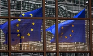 EU flags reflecting off the EU headquarters in Brussels