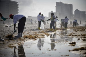 Deepwater Horizon: BP oil spill: Workers clean the oil washed ashore