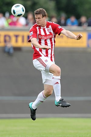 Kits: Robert Huth of Stoke City leaps to head the ball