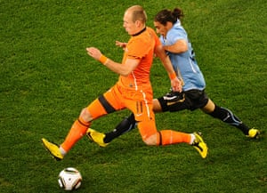 Holland versus Uruguay: Netherlands' striker Arjen Robben shields the ball from Martin Caceres 