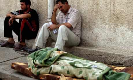 The body of an Iraqi lies outside a morgue in Baghdad in October 2006