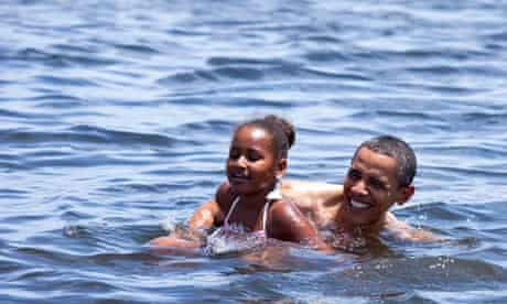 Barack Obama and his daughter Sasha swim at Alligator Point in Panama City Beach, Florida