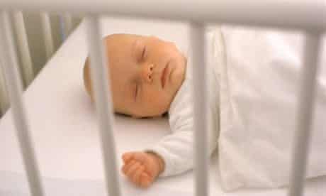Sleeping baby in cot