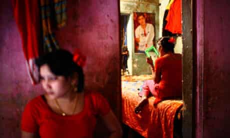 Asha and Suborna (background), young bonded sex workers in a brothel in Faridpur, Bangladesh. 