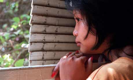 A 16-year-old Cambodian girl hides after being rescued from a brothel were she was forced to work.