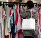 A shopper searches for clothing bargains at Bolton Market.