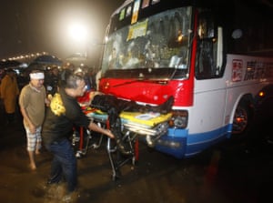 Manila bus hijack: Rescue units wheel a body away