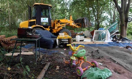 A bulldozer demolishes an illegal camp of Roma in Villeneuve d'Ascq, near Lille, northern France