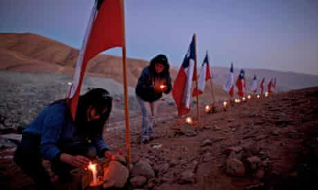 Trapped Chilean miners-women plant flags, light candles