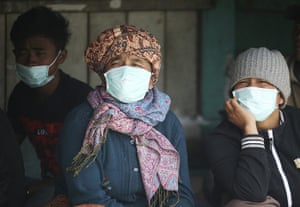 Sinabung volcano: Villagers wear face masks to protect themselves from volcanic ash