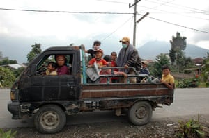 Mount Sinabung volcano: A family group leave Naman village on a pick up truck