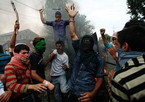 24 hours in pictures: Kashmiri protesters shout slogans near a burning government vehicle, India