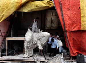 24 hours in pictures: ndian artists works on an idol of Hindu God Ganesha