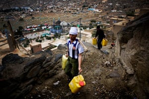 24 hours in pictures: Afghan youths carry canisters filled up with water climb up the hill