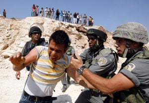 24 hours in pictures: Israeli border police officers remove a Palestinian demonstrator 