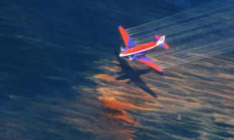 A US Coast Guard aircraft sprays oil dispersant over the Gulf of Mexico