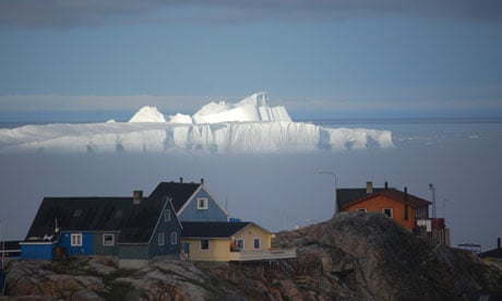 An ice shelf looms over houses in Nuuk, the capital of Greenland.