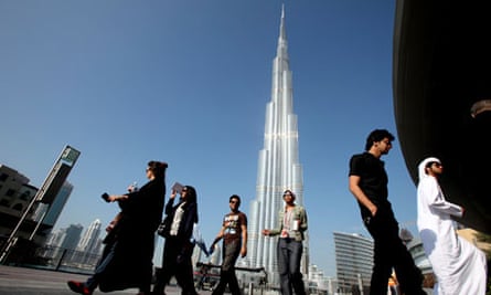 A group of Emiratis walk past the Burj Dubai Tower