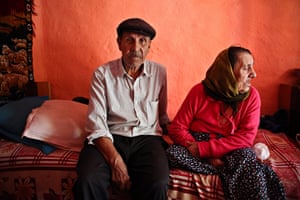 Roma in Romania: A Roma man poses for a portrait next to his disabled wife