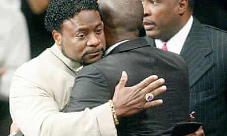 Bishop Eddie Long embraces a friend at his New Birth Missionary Baptist Church
