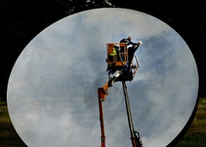 Kapoor: A worker cleans Anish Kapoor's sculpture Sky Mirror 