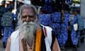 Hindu holy man walks past as soldiers guard ahead of the Ayodhya verdict