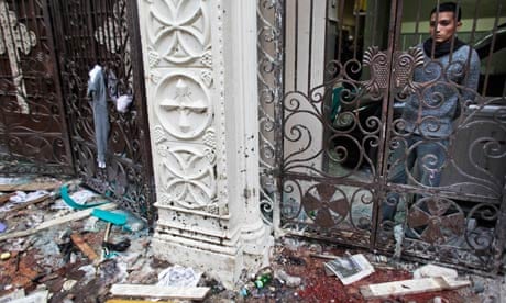A man observes the scene of the bomb blast from within the Coptic church in Alexandria, Egypt