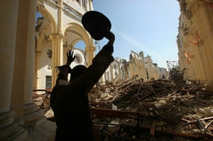 Haiti then and now: February 2010: An earthquake survivor prays inside the destroyed cathedral