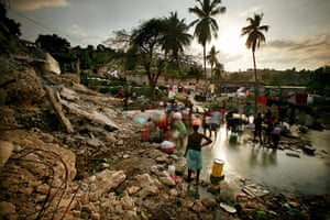 Haiti then and now: February 9, 2010: Earthquake survivors bathe and wash clothes in a stream